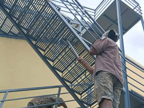 Worker finishing a fabricated steel staircase