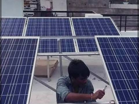 Technician fixing solar panels on the mounting structure