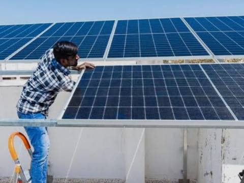 Technician checking a completed rooftop solar array
